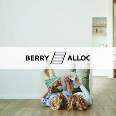 berry alloc logo imposed over a mother and child lying against a wall on a wooden floor
