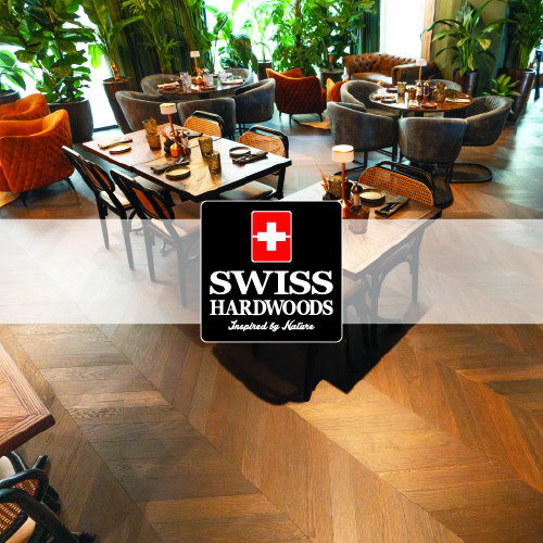swiss hardwood logo imposed over photo of restaurant with patterned wooden flooring